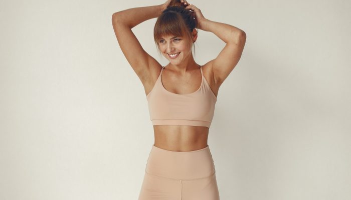 Beautiful girl in yoga studio. A woman doing a yoga. Lady in a top.