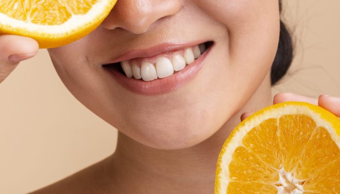 close-up-happy-asian-woman-with-orange