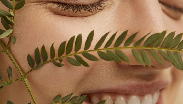 close-up-smiley-model-posing-with-plant