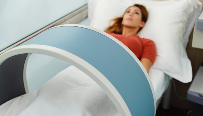 Close-up of woman having magnetotherapy at medical clinic.