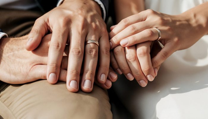 couple-holding-hands-with-wedding-rings
