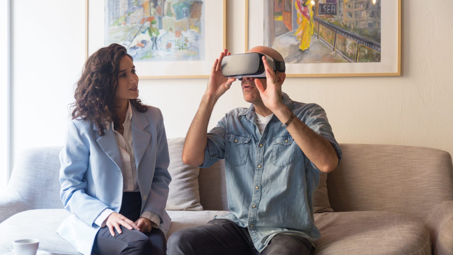 Interior designer talking to customer in VR headset. People using virtual reality technology at home. Virtual interior presentation concept