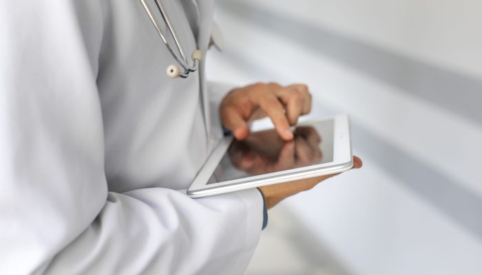 doctor-hands-using-modern-tablet