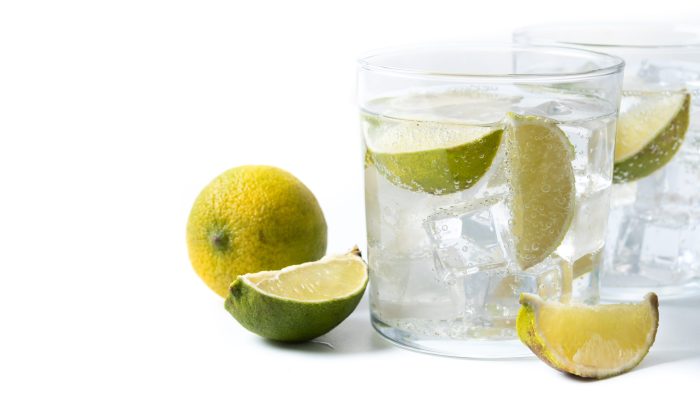 Glass of vodka tonic cocktail isolated on white background.