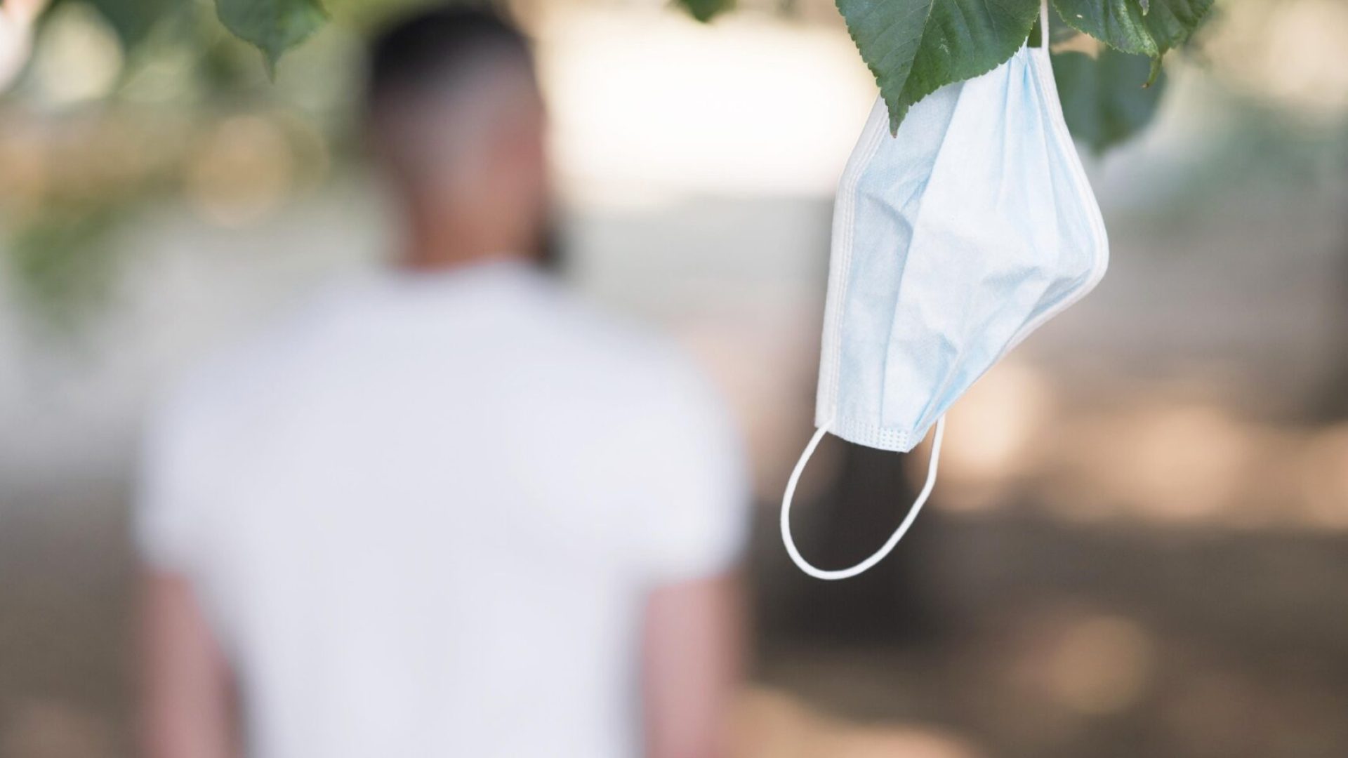 man-leaving-his-medical-mask-tree