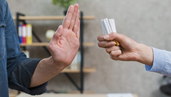 man-refusing-bunch-cigarettes-offered-by-his-female-friend