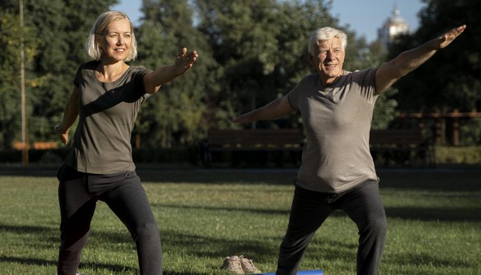mature-couple-doing-yoga-outside