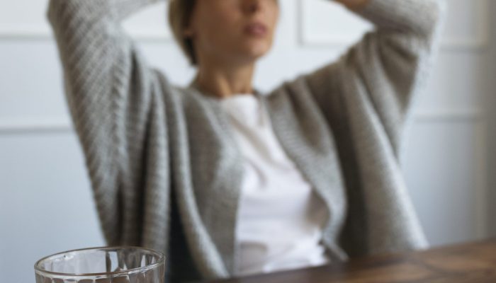 medium-shot-blurry-woman-sitting-chair
