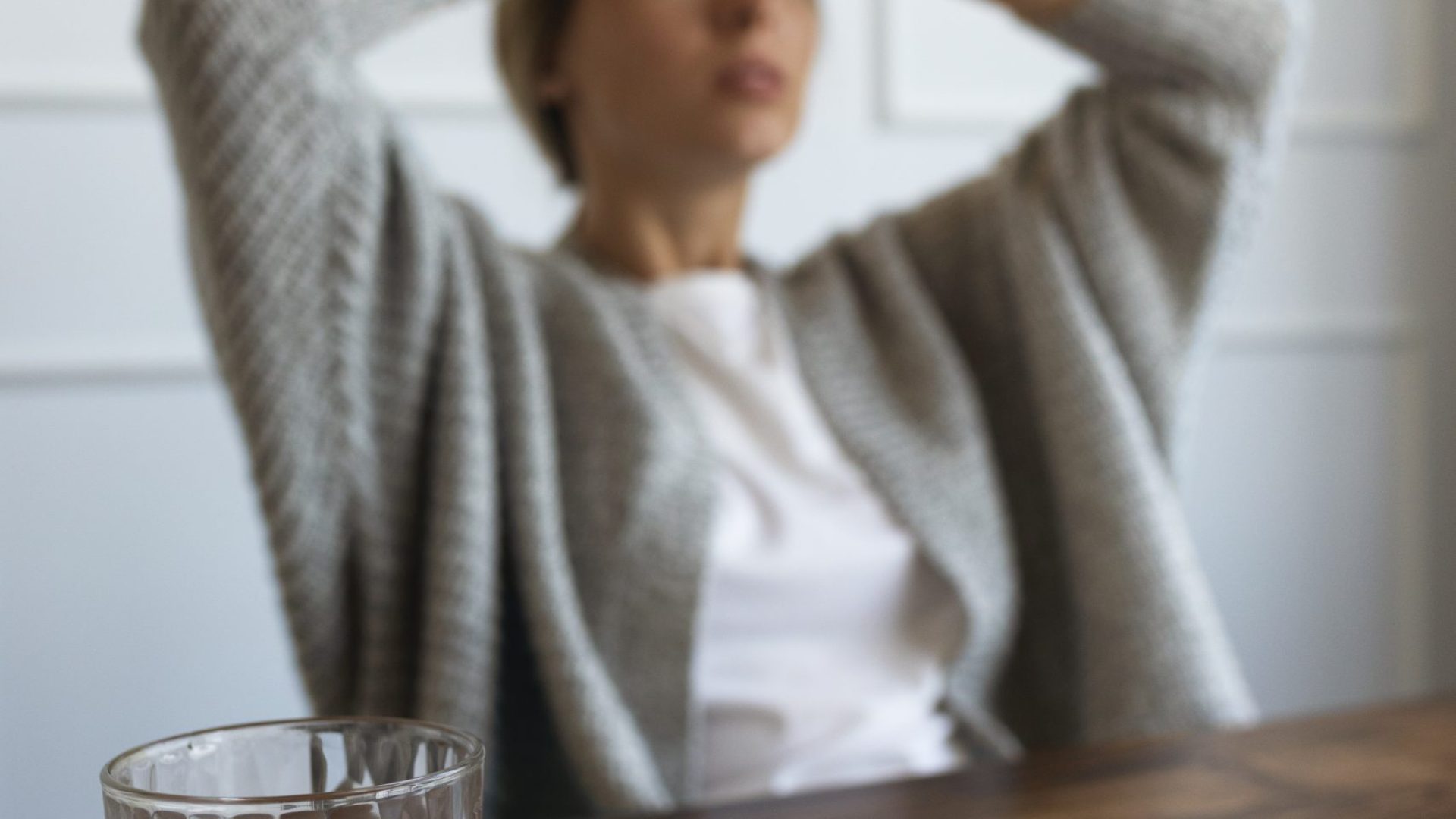 medium-shot-blurry-woman-sitting-chair