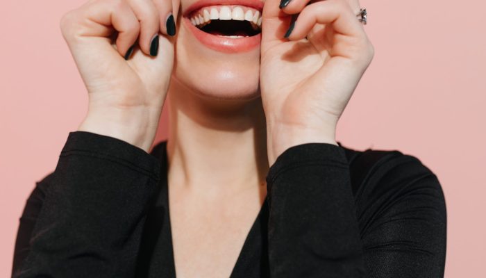 Excited woman posing with black head scarf. Studio shot of laughing fashionable girl.