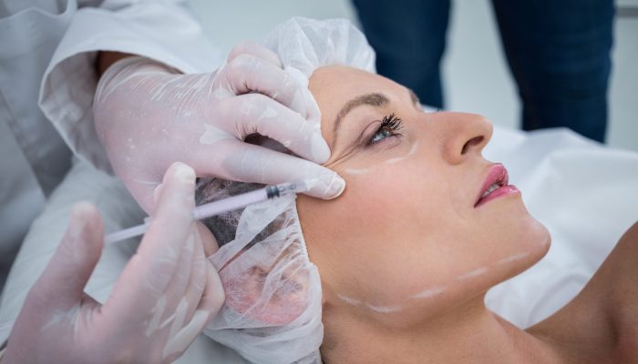 Woman receiving botox injection at clinic