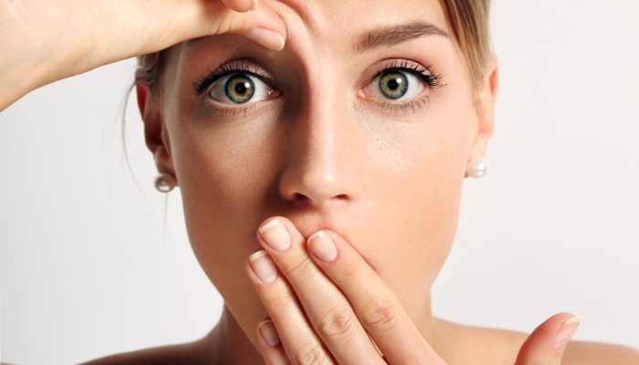 young girl wondering that hse have first wrinkle on her forehead