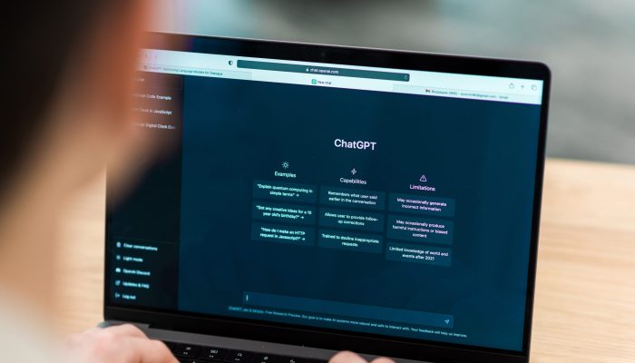 Close view of a man with opened AI chat on laptop