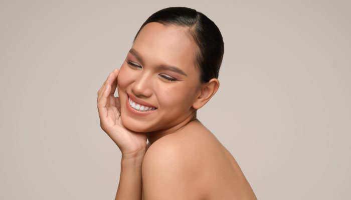 Portrait with manicure hands of beautiful asian woman touch cheek and smile, beautiful natural clean skin nature make up,  fresh spa female beauty cometic, copy space