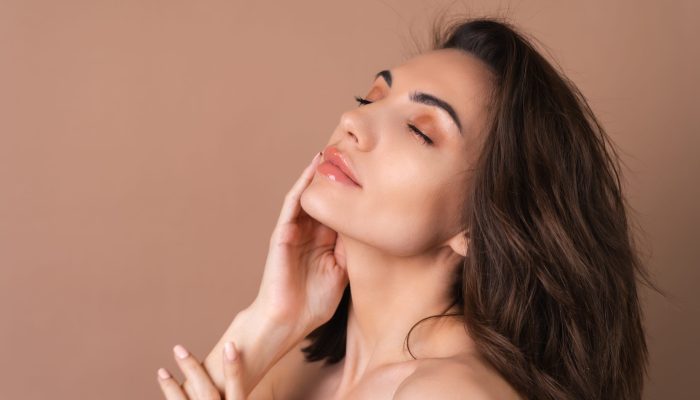 Close-up beauty portrait of a topless woman with perfect skin and natural make-up