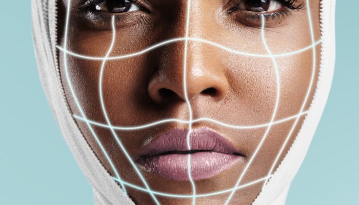 portrait of a black woman with bandaged head and surgery lines on her face