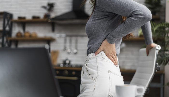 side-view-woman-having-backache-while-working-from-home
