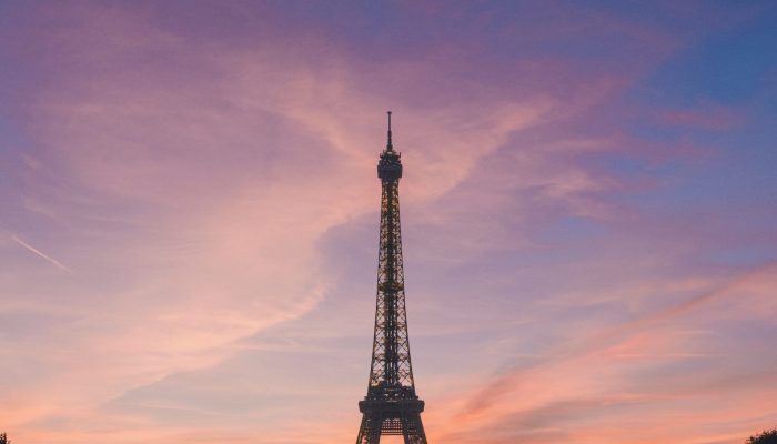A silhouette of an Eiffel Tower in Paris, France with beautiful scenery of sunset in the background