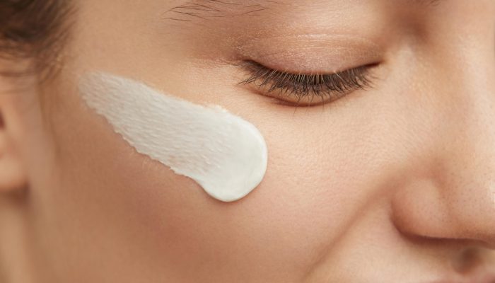 smiley-woman-posing-with-face-cream