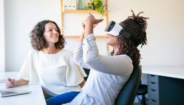 Focused workers testing new device. Concentrated workers setting VR headset. Technology concept