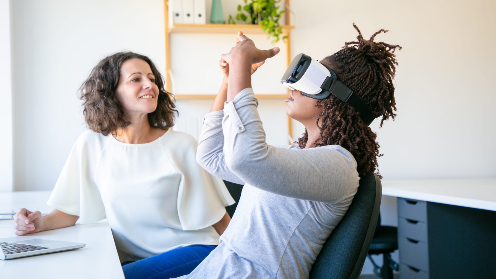 Focused workers testing new device. Concentrated workers setting VR headset. Technology concept