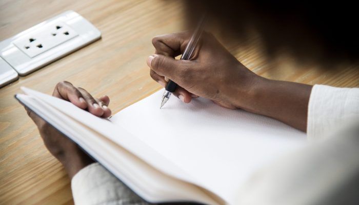 Rear view of woman writing a note