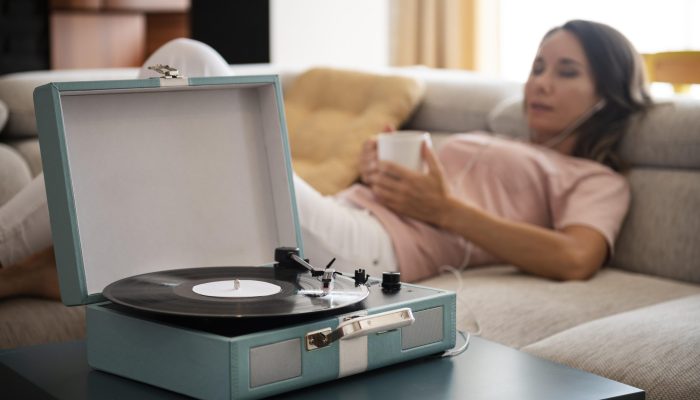 woman-relaxing-home-while-listening-vinyl-music