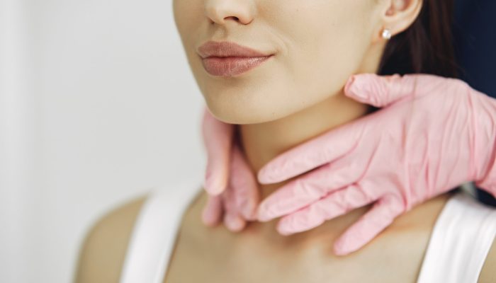 Cosmetologist holds hands near client's face. Woman with cosmetologist. Lady in a beauty studio.