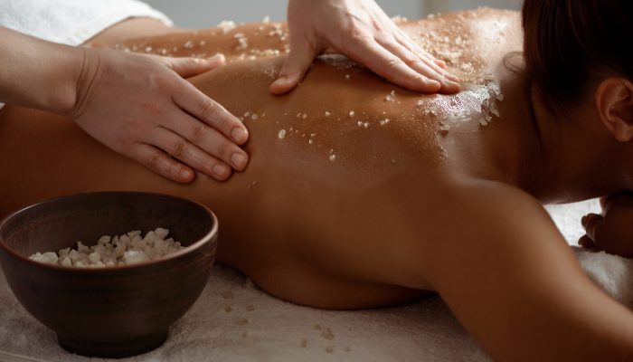 Young beautiful brunette girl relaxing in spa salon. Copy space.